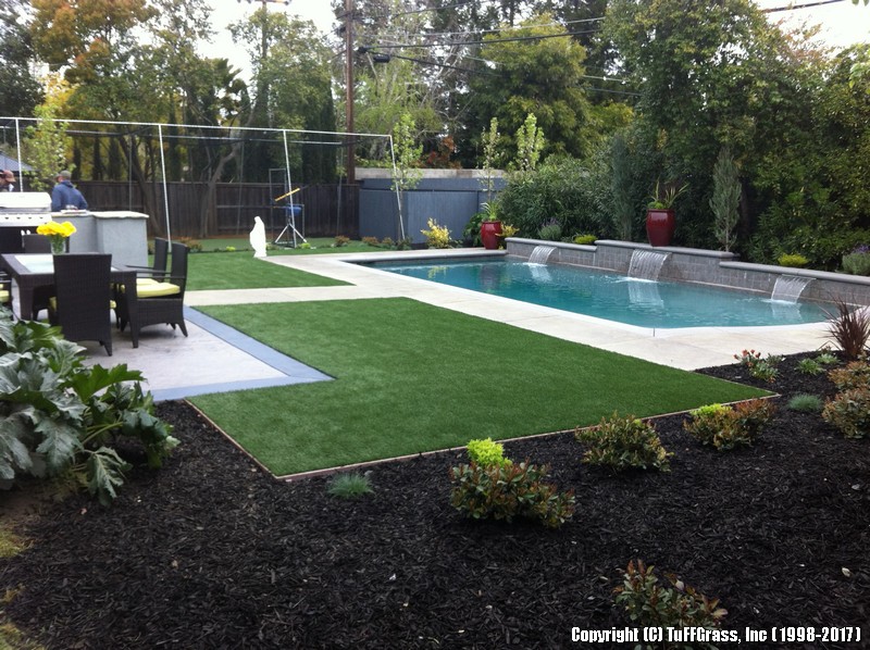 Angular edges enhances the formal look of this active residential backyard. The bender board trim separates the gardens from the artificial grass areas, along 3 sides of the pool.