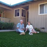 This senior couple and their puppy dog are enjoying their new artificial grass front lawn in Auburn CA