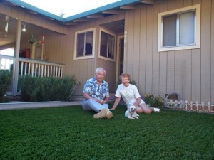 This senior couple and their puppy dog are enjoying their new artificial grass front lawn in Auburn CA