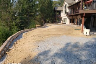 A photo of a rural Colfax, CA backyard after a new weeping retaining wall has been installed waiting for it's artificial grass solution!