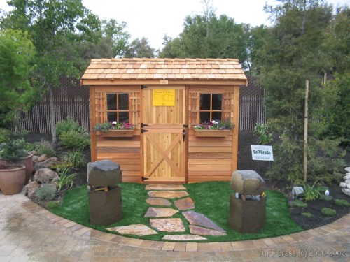 This is a photo of how Artificial grass lawn installation sets off this "tiny house" "she shed" and looks beautiful next to all the plants and planters in Placer County.