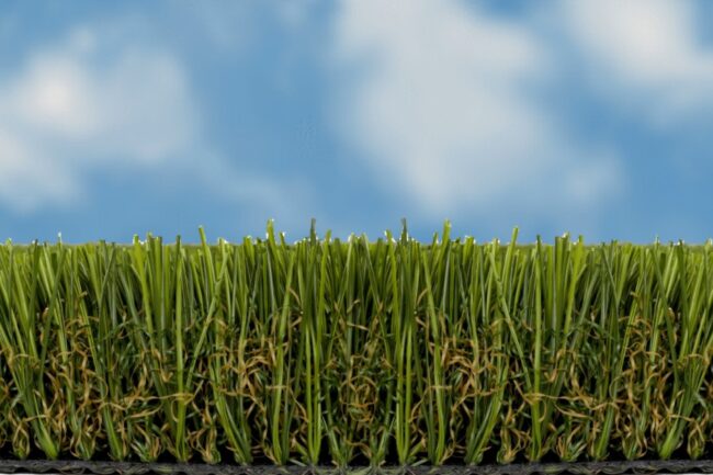 Artificial Grass Installer logo background image of a beautiful blue sky, puffy white clouds and artificial grass side view